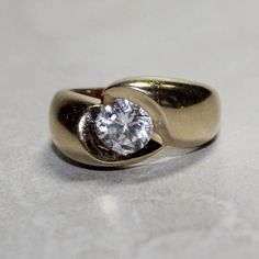 a gold ring with a diamond in the center