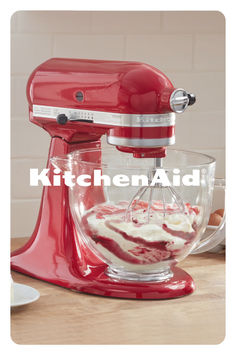 a red kitchen aid mixer sitting on top of a counter