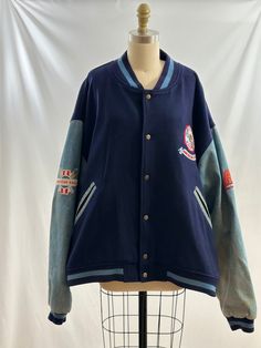 This vintage 90s American Eagle Outfitters jacket is so cool. Varsity style, it as wool body with denim sleeves and colorful embroidered patchwork on arms as well as the back.   -Vintage 90s -Wool and denim, colorful embroidered patchwork -Dry clean only Measurements:  marked a men's extra large *Sleeve 25 inches *Bust 29 inches *Length 26 1/2 inches *Bottom opening 25 1/2 inches *This item is pre-loved and there may be minor flaws to the garment. Not to worry if there is anything major we will Fall Varsity Jacket With Embroidered Patch And Long Sleeves, Fall Varsity Jacket With Embroidered Patch, Winter Cotton Varsity Jacket With Patchwork, Retro Outerwear With Embroidered Patch And Long Sleeves, Retro Long Sleeve Outerwear With Embroidered Patch, Cotton Varsity Outerwear With Patchwork, Retro Embroidered Cotton Outerwear, Retro Cotton Outerwear With Embroidery, Retro Cotton Varsity Jacket With Patchwork