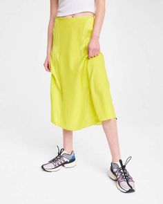 100% silk charmeuse, 100% of your standout looks. The Lucille skirt in lime green is an easy day-to-night midi for summer that will brighten up any warm-weather wardrobe. With a flattering a-line silhouette, it’s fitted at the waist and flares along the knee. Notice the mix of both matte and shine in the silk-among the many intricacies of this hand-selected fabric and expertly executed style. With an invisible zipper at the center back, the mixed-media detailing, and more, this midi takes detail Black Bodycon Skirt, Jean Midi Skirt, Fitted Midi Skirt, Home Bunch, Camo Skirt, Jacquard Skirt, Paneled Skirt, Leather Midi Skirt, Slip Skirt