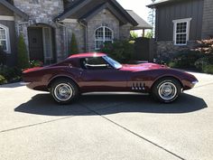 a red car parked in front of a house