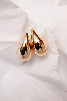 If you're looking for a stylish and elegant accessory to complete your outfit, look no further than our large gold teardrop earrings. These earrings are expertly crafted using only the highest quality gold, ensuring that they will maintain their shine and beauty for years to come. The teardrop shape of the earrings adds a touch of sophistication and femininity to any look, making them the perfect choice for both formal and casual occasions. With their large size 1.9in height and 1.1in width, and Gold Teardrop Earrings, Sequin Pant, Bow Crop Tops, Cream Crop Top, Asymmetric Jacket, Outfit Look, Cotton Coat, Gold Earring, Satin Slip