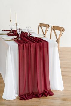 the table is set with white and red linens