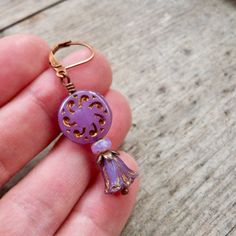 These beautiful purple earrings are sure to brighten anyone's day! These Czech glass bead compliment one another perfectly. The top bead is a 13mm purple sun wheel bead, with a bronze Picasso wash, filling in a subtle design. This is separated from the tulip bead by a 3x5 opal orange bead and a copper bead cap.The purple tulip bead has a repeat of the bronze wash on the edges of the bead, accenting the tulip shape. These earrings are also available with antique brass. Happy to put a titanium ear Lavender Pierced Earrings For Gift, Purple Czech Glass Earrings For Gift, Nickel-free Lavender Earrings Gift, Gift Lavender Nickel-free Earrings, Adjustable Purple Flower Earrings As Gift, Adjustable Purple Flower Earrings For Gift, Adjustable Lavender Jewelry With Matching Earrings, Bohemian Lavender Drop Earrings, Purple Flower-shaped Pierced Earrings