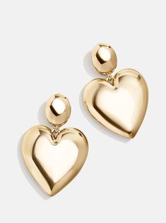 The Sheri Earrings make heart earrings modern. This pairing of gold drop earrings features a simple stud connected to an elegantly oversized glossy gold heart drop. We love this style for date night, girls' night, or really any night, as a matter of fact. Gold Medallion Necklace, Bridal Earrings Studs, Ups Shipping, Safety Pin Earrings, Heart Shaped Jewelry, 18k Gold Earrings, Spring Event, Statement Drop Earrings, Party Earrings