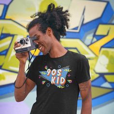 "Take me back to the best decade since the 80s! Everything was better in the 90s. Retro 90s Shirt | Retro Shirt | 90s Kid Shirt | Nostalgia Shirt | Best Of The 90s Shirt | 90s Kid Tee This t-shirt puts a new spin on casual comfort. Made from very soft materials, this tee is 100% cotton for solid colors. Heather colors and sports grey include polyester. The shoulders have twill tape for improved durability. There are no side seams. The collar is made with ribbed knitting to prevent curling damage.   * Unisex Basic Softstyle T-Shirt - Gildan 64000* * 100% cotton (fiber content may vary for different colors) * 4.5 oz/yd² (153 g/m²) * Pre-shrunk * Shoulder-to-shoulder taping * Eurofit * Tear-away label * Runs true to size * Quarter-turned to avoid crease down the center + Please check size cha Garment Industry, 90s Shirts, Take Me Back, 90s Retro, 90s Kids, Retro Shirts, Retro 90s, The 80s, The 90s