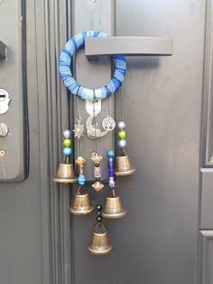 a bunch of bells that are hanging on a door