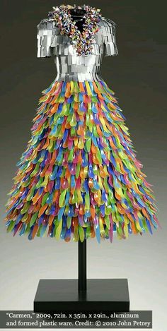 a dress made out of plastic beads on a display stand with the caption'what do you think? '