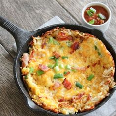 an omelet in a cast iron skillet on a wooden table