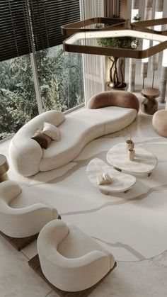 a living room filled with lots of white furniture