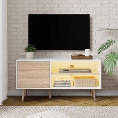 a white and yellow entertainment center with a flat screen tv mounted on it's side