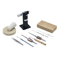 an assortment of tools are displayed on a white background, including a sharpener and other items