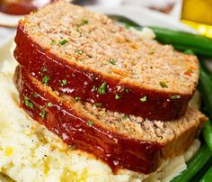 meatloaf and mashed potatoes in a bowl with green beans on the side