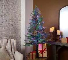 a small christmas tree is lit up with colorful lights