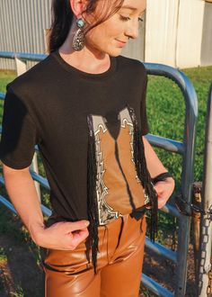 Get ready to ride with the Buck Around Fringe Chaps Tee! This playful tee features a unique design with bucking broncos, chaps, and rodeo-inspired "let em ride" text. Perfect for any cowboy or cowgirl looking to add a quirky and fun touch to their wardrobe. Yee-haw! Fringe Chaps, Cowgirl Look, Yee Haw, Rodeo, Get Ready, Unique Design, Cowboy, Unique Designs, Wardrobe