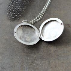 "This vintage sterling silver locket is engraved with a classic swirl design on the front and back. The large round locket opens to revealing two compartments awaiting your favorite photos. The pendant is suspended from a new sterling silver chain adorned with tiny amethyst stones at the clasp. Locket 30 mm Necklace 24\" (61cm) ✦All of our lockets ship with complimentary insurance✦ ✤Our entire selection of lockets can be found here✤ http://www.etsy.com/shop/LexiandGem?section_id=7506972" Ornate Silver Jewelry With Engraving Option, Engraved White Gold Sterling Silver Locket Necklace, Antique Sterling Silver Locket Necklace For Anniversary, Silver Sterling Locket Necklace With Engraving Option, Heirloom Silver Jewelry With Engraving Option, Silver Oval Pendant Jewelry With Engraving Option, Classic Antique Silver Jewelry With Engraving Option, Heirloom Silver Locket Necklace With Oval Pendant, Antique Sterling Silver Locket Jewelry