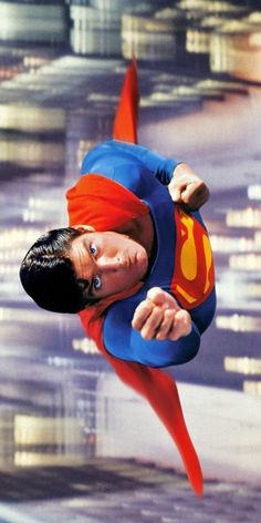 a man flying through the air while wearing a superman costume