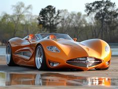 an orange sports car sitting on top of a parking lot next to a body of water