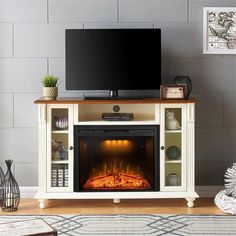 a living room with a fireplace and tv on the entertainment center in front of it