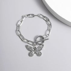 Introducing Our Stunning Butterfly Pendant Chain Bracelet Welcome to our store, where elegance meets affordability! Our Butterfly Pendant Chain Bracelet is a timeless piece that adds a touch of grace to any outfit. Crafted with precision and passion, this bracelet embodies the essence of charm. This bracelet is designed for the modern woman who appreciates beauty and quality. With its straight-line buckle chain and delicate butterfly pendant, it effortlessly blends Korean fashion sensibilities with international appeal. Embrace your femininity with this exquisite piece, perfect for both casual outings and special occasions. Product Features: Chain & Link Bracelet Made of high-quality zinc alloy Charming bowknot design Easy-hook clasp for convenience Available in a stunning silver color Lig Minimalist Alloy Charm Bracelet Gift, Minimalist Alloy Chain Bracelet Gift, Minimalist Alloy Chain Bracelet As Gift, Trendy Stainless Steel Charm Bracelet, Nickel Free Metal Chain Bracelet, Minimalist Silver Alloy Bracelets, Trendy Alloy Bracelet With Adjustable Chain, Nickel Free Link Bracelets, Nickel-free Link Bracelets