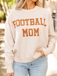 Get ready for fall game days with this new arrival! Calling all football moms, we've got the cutest, super chic outfit for your next game day! This classic crew neck jacquard sweater features a FOOTBALL MOM graphic across the front for a chic way to cheer on your favorite player. Crew neckline FOOTBALL MOM graphic Relaxed fit Drop shoulder 52% Viscose, 28% Polyester, 20% Nylon Body length measurement: 25" from a S. Bust measurement: 22" from a S. Model is wearing a S. Collegiate Game Day Winter Sweater, Collegiate Sweatshirt For Game Day In Fall, Collegiate Sweater For Game Day In Winter, Collegiate Style Sweatshirt For Game Day In Fall, Fall Game Day Crew Neck Sweatshirt, Varsity Sweater For Game Day In Winter, Sporty Sweater For Game Day, Fall, Game Day Crew Neck Sweater With Ribbed Cuffs, Fall Sports Fan Crew Neck Sweatshirt