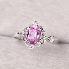 ◆ The ring is handcrafted from sterling silver and decorated with a dazzling 8*6 mm pink sapphire and CZs. It is suitable for engagement/anniversary/daily occasion. ◆ Production Description: Main stone Type: Lab Pink Sapphire Main Stone Shape: Oval Cut Main Stone Size: 8*6 mm(1.75ct) Side stone: CZ Metal: 925 Sterling silver - Other options available in the drop down menu ◆ Customization: √Free for Add Engraving √Other Metal Type Available √Other Gemstones & Shapes Available √Personalization Req Elegant Pink Amethyst Ring With Halo Setting, Pink Cubic Zirconia Classic Ruby Ring, Pink Sterling Silver Diamond Ring With Accent Stones, Silver Pink Sapphire Ring As Gift, Silver Pink Sapphire Rings For Gift, Pink Sapphire Ring With Center Stone In Sterling Silver, Pink Amethyst Ring In Sterling Silver For Anniversary, Pink Topaz Ring With Halo Setting As Gift, Pink Sapphire Ring With Sterling Silver