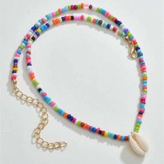 This Colorful Beaded Cowrie Puka Seashell Necklace Is A Wonderful Addition To Your Wardrobe And Your Style! A Fun And Unique Piece! Colorful Shell Bead Necklaces For Vacation, Colorful Beads Shell Necklace For Vacation, Colorful Shell Bead Necklaces For Beach, Colorful Beaded Shell Necklaces For Vacation, Colorful Shell Beaded Necklaces, Colorful Beaded Shell Necklace In Strand Shape, Beach Shell Necklaces With Colorful Beads, Multicolor Shell-shaped Jewelry For Beach, Beaded Shell Necklace For Summer Festivals