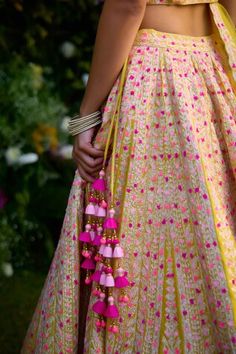 Raspberry purple raw silk lehenga with an attached cancan and multi-colored gota and thread embroidery. Comes with a padded blouse, a dupatta and a belt. - Aza Fashions Festive Pink Sharara With Tassels, Festive Pink Tassel Sharara, Bohemian Sharara With Gota Work For Reception, Bohemian Sharara With Dori Work For Wedding, Festive Sharara With Tassels For Reception, Bohemian Wedding Sharara With Dori Work, Multicolor Anarkali Dupatta With Tassels, Diwali Anarkali Set With Tassels And Traditional Drape, Bollywood Anarkali Set With Tassels For Festive Occasions