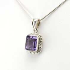 Large emerald cut 10x12mm genuine amethyst gemstone is set in sterling silver in Nepal. Handmade blue topaz pendant is 1 1/8 inches long and 5/8 inch wide and is sold separate from the snake chain shown. To clean pendant: simply use a jewelry polishing cloth to brighten the silver. Style Number: 7732 Metal: 925 Sterling Silver Gemstone: Genuine Amethyst Dimensions: 1 1/8 inches long and 5/8 inch wide Handmade in Nepal Fine Jewelry With Gemstone Accents Rectangular Shape, Fine Jewelry With Rectangular Gemstone Accents, Rectangular Gemstone Fine Jewelry, Formal Sterling Silver Rectangular Pendant, Classic Faceted Rectangular Jewelry, Classic Rectangular Faceted Jewelry, Sterling Silver Rectangular Pendant Fine Jewelry, Classic Jewelry With Gemstone Accents And Rectangular Stone, Fine Jewelry Sterling Silver Rectangular Pendant