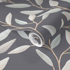 a grey and gold wallpaper with white leaves on it's side, in an elegant pattern