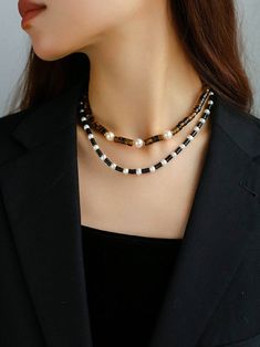 Upgrade your style with our timeless Black Onyx Pearl Necklace. Featuring smooth onyx beads and lustrous pearls, this necklace effortlessly combines classic beauty with modern sophistication. Metal: 18ct Recycled Gold Plated On Brass Gemstone: Black Onyx,Pearl Length: 410-460mm Weight: 32g Pearl Necklaces, Tigers Eye Gemstone, Onyx Bead, Tiger Eye Stone, Pearl Gemstone, Tiger's Eye, Gold Plated Necklace, Classic Beauty, Baroque Pearls