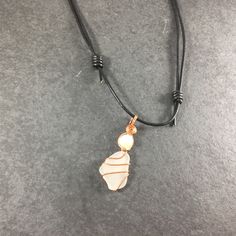 This Beautiful genuine Sea glass necklace is truly unique. Made from white frosted Lake Erie Beach Glass naturally tumbled by the waves, each piece of Beach Glass is its own unique shape, and hand chosen for your necklace. It is wire-wrapped by hand with pure copper wire and accented with a genuine white freshwater pearl. The beautiful pendant is then hung on a adjustable leather cord necklace that can be worn at 14 inches or as long as 26 inches. I take great care in the creation of each and ev Blue Lace Agate Necklace, Beach Glass Necklace, Surf Jewelry, White Sea Glass, Amazonite Necklace, Carnelian Pendant, Leather Corded Necklace, Healing Crystal Jewelry, White Sea