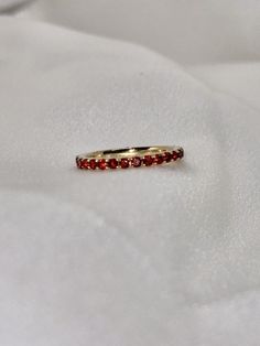 "A timeless and classic design, symbolizing commitment and love. Perfect for everyday wear or dressed up for special occasions. Make a bold statement in our Genuine Garnet Eternity Ring, handcrafted in 14k yellow gold. This ring is not adjustable and is available in US size 7 1/4.  Item Specifications: Materials: 14k Solid Yellow Gold Gemstone: Natural Garnet Total Gold Weight: 2.06 ct. Total Garnet Carat Weight: 1.22 ct.  ★  Each order will be beautifully packaged in a jewelry box and comes with a drawstring pouch that's perfect for travel. LiebeJewelry's products are handcrafted and all materials are genuine and ethically sourced. Our products are made with genuine materials and will not tarnish in the shower or irritate the skin. If you have any additional questions about this ring, jus Oval 14k Gold Eternity Band, Luxury Ruby Eternity Band As A Gift, Elegant Red Ruby Eternity Band, Elegant Red Round Eternity Band, Elegant Red Stackable Promise Rings, Ruby Eternity Band With Prong Setting For Formal Occasions, Formal Ruby Eternity Band With Prong Setting, Elegant Red Round Cut Eternity Band, Elegant Ruby Gemstone Eternity Band