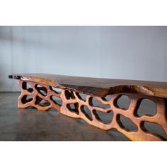 a wooden bench made out of wood with holes in it