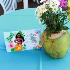 there is a vase with flowers in it and a card on the table next to it