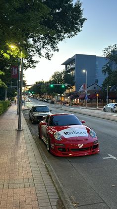 two cars parked next to each other on the side of a road near a street light