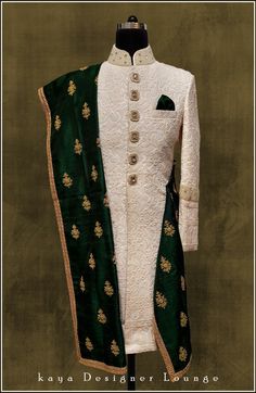 a green and white suit with gold details