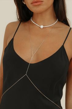 Our first ever body chain is here to stay, featuring an elongated flat box chain in 14k gold-filled. Created to delicately wrap you, this body chain is meticulously crafted with precision and care &  is the epitome of timeless luxury. Wear the Tara body chain all year round - over a slip dress, a bikini, with jeans or your favorite slip dress.

Chain Dimensions: 1.2mm flat box
Measurements: 23” Necklace & 30” Waist
Waterproof & tarnish resistant Delicate Chain Jewelry For Party, Delicate Party Jewelry With Chain, Elegant Adjustable Chain Pearl Necklace, Elegant Adjustable Pearl Necklace With Chain, Elegant White Gold Chain Necklace With Adjustable Chain, Elegant White Gold Adjustable Chain Necklace, Elegant Double Chain Necklace, Gold Chain Necklace For Wedding, Elegant Gold Double Chain Jewelry