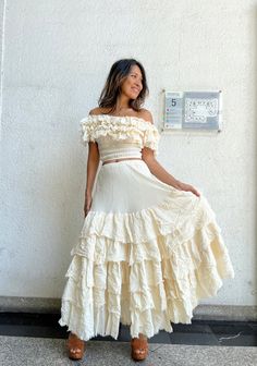 Bohemian ruffle maxi cream skirt with un finish hem and each layer. Elastic waist 100% raw cotton. Lined. Color Cream and White Handmade ruffle off shoulder blouse. Un finished hem at all the layers. Smock under a bust and waist. 100% natural cotton. Can be worn as a cover and off shoulder and one side shoulder styles. 2 colors. Cream White. Model 5'6 Measurements: TOP Bust 30 up to 50 inches. Shoulder elastic 30 up to 65 inches. Waist 22 up to 46 inches. Length 14.5 inches. Measurements: for th Spring Wedding Maxi Skirt With Ruffles, Summer Wedding Ruffled Maxi Skirt, Bohemian Tiered Cream Maxi Dress, Bohemian Cream Tiered Maxi Dress, Summer Wedding Skirt With Ruffles, Floor-length Ruffled Maxi Skirt For Wedding, Wedding Floor-length Ruffled Maxi Skirt, White Ruffled Maxi Skirt, Cream Maxi Length Dress With Flowy Skirt