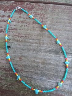 This necklace features turquoise stones and colorful western seed beads. Green Southwestern Beaded Necklaces For Festival, Southwestern Green Beaded Necklaces For Festivals, Southwestern Green Beaded Necklace For Festivals, Beaded Turquoise Necklace With Round Beads For Festival, Beaded Turquoise Necklace For Festival, Turquoise Necklace With Spacer Beads For Beach, Turquoise Necklace With Tiny Beads For Beach, Festival Beaded Turquoise Necklace, Turquoise Beaded Hippie Necklace