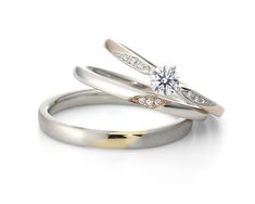 two wedding rings, one with a diamond on top and the other with a gold band