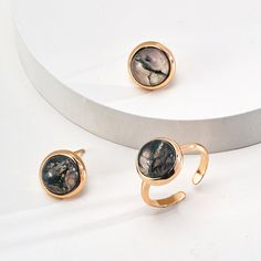 This delicate ring features stunning aquatic agate gemstones. The setting is meticulously crafted and the intricate details enhance the natural beauty of the stone, allowing its delicate hues to sparkle in the light. The adjustable strap ensures a comfortable fit, making it a versatile and elegant addition to any jewelry collection. Metal: 18K Recycled Gold Plated Vermeil on Recycled Sterling Silver,Recycled Sterling Silver Gemstone: Onyx 10mm Adjustable Ring Size: US 8 Water Grass, Edison Pearls, Gemstone Stud Earrings, Onyx Gemstone, Tiger Eye Stone, Gemstone Studs, Recycled Gold, Delicate Rings, Recycled Sterling Silver