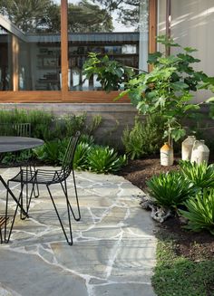 a table and chairs sitting on a stone patio