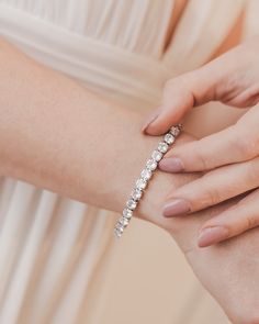 The perfect accessory for any bride that wants a bit of sparkle, our Presley CZ Bracelet can be worn on its own or layered with another piece. Designed with a single strand of round, sparkling cubic zirconia stones, this bracelet will shine on long after your wedding day. Cubic zirconia 1/8" wide; 6"-7" length Includes matching detachable extender Hypoallergenic, lead-free & nickel-free Style #4900 Dazzling Tennis Bracelet With Sparkling Stones For Wedding, Wedding Tennis Bracelet With Sparkling Stones, Wedding Tennis Bracelet With Sparkling Cubic Zirconia, Dazzling Tennis Bracelet With Diamond Accents For Wedding, Classic Sparkling Diamond Bracelet For Wedding, Wedding Crystal Tennis Bracelet With Brilliant Cut, Classic Crystal Bracelet With Sparkling Cubic Zirconia, Wedding Crystal Tennis Bracelet Sparkling, Crystal Sparkling Tennis Bracelet For Wedding