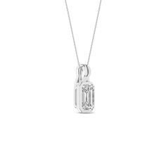 Embrace elegance with our Twisted Emerald Bezel Pendant Necklace. It features a brilliant emerald-shaped lab-grown diamond, delicately set in a sleek bezel setting, ensuring it catches the light from every angle. The twisted bail design adds a unique twist, symbolizing the intertwining of classic and contemporary styles. Whether dressing up for a special occasion or adding a touch of sophistication to your everyday look, this diamond pendant necklace is the perfect choice. Classic White Gold Emerald Necklace With Diamond Accents, Classic Emerald Necklace With Diamond Accents For Formal Occasions, Classic Emerald Necklace With Diamond Accents For Formal Events, Formal Emerald Cut Cubic Zirconia Necklace, Classic Emerald Pendant Necklace With Diamond Accents, Formal Emerald-cut Solitaire Necklace In Cubic Zirconia, Formal Emerald Cut Solitaire Necklace With Cubic Zirconia, Emerald Cut Diamond Necklace With Accents For Formal Events, Formal Emerald Cut Diamond Necklace With Diamond Accents