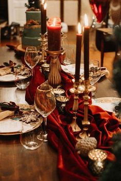 the table is set with wine glasses, candles and napkins for dinner guests to enjoy