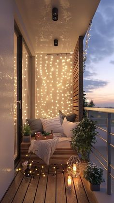 the balcony is decorated with string lights and pillows, candles on the wooden flooring