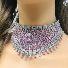 This majestic pink zirconia choker set is a stunning blend of heritage and modern style.  Imagine stepping into a grand event, adorned in this meticulously handmade necklace set, where every stone sparkles brilliantly, catching the light with each movement. The intricate design, featuring a necklace, earrings, and maang tikka, exudes elegance and royalty, inspired by the rich tradition of Indian craftsmanship. The pink zirconia stones, paired with shimmering silver accents, offer a contemporary Ad Necklace Set, Jewelry Ad, Diamond Choker Necklace, Necklace Set Indian, Bridal Choker, Maang Tikka, Diamond Choker, Cubic Zirconia Necklace, Pakistani Jewelry