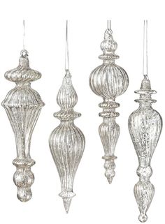 four glass ornaments hanging from strings on a white background