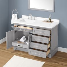 a bathroom vanity with drawers and a mirror